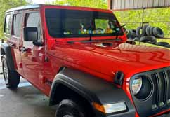 Mobile Vehicle Washing Red Jeep Wrangler by High Performance Pressure Washing based in Athens, TX.